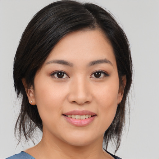 Joyful asian young-adult female with medium  black hair and brown eyes