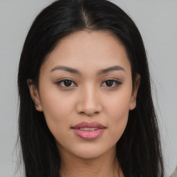 Joyful asian young-adult female with long  brown hair and brown eyes