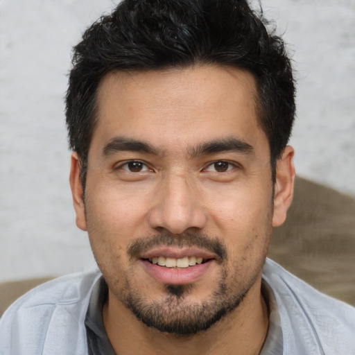 Joyful white young-adult male with short  black hair and brown eyes