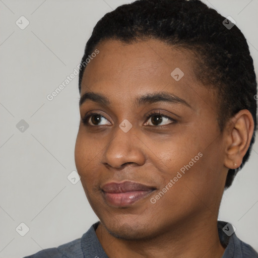 Joyful black young-adult female with short  black hair and brown eyes