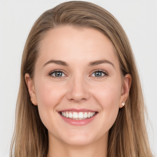 Joyful white young-adult female with long  brown hair and grey eyes