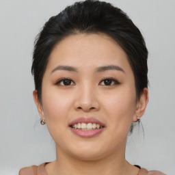 Joyful asian young-adult female with medium  brown hair and brown eyes