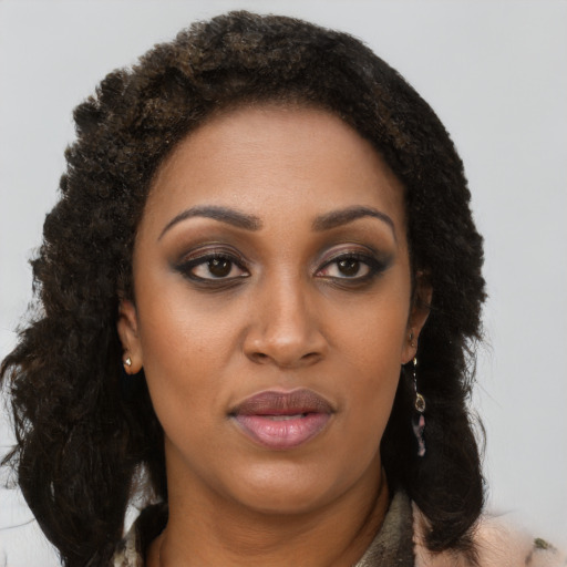 Joyful black young-adult female with long  brown hair and brown eyes