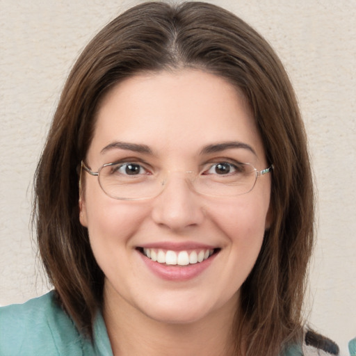 Joyful white young-adult female with medium  brown hair and green eyes