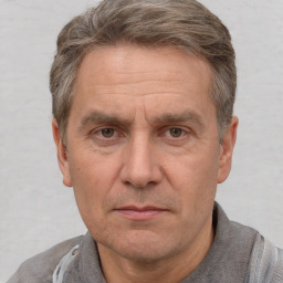 Joyful white middle-aged male with short  brown hair and brown eyes