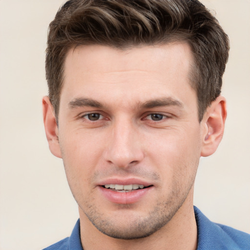 Joyful white young-adult male with short  brown hair and grey eyes