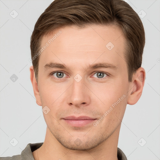 Joyful white young-adult male with short  brown hair and grey eyes