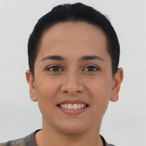Joyful latino young-adult female with short  brown hair and brown eyes