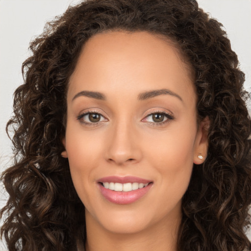 Joyful white young-adult female with long  brown hair and brown eyes