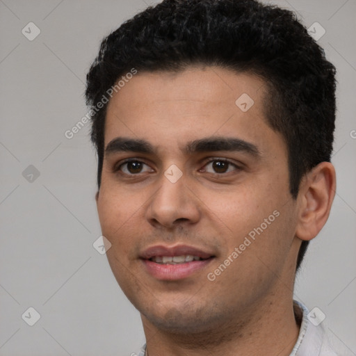 Joyful white young-adult male with short  black hair and brown eyes