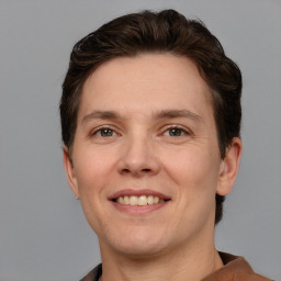 Joyful white adult male with short  brown hair and brown eyes