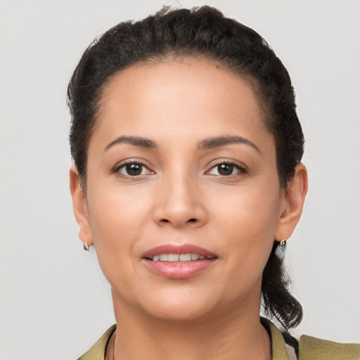 Joyful latino young-adult female with short  brown hair and brown eyes