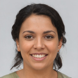 Joyful latino young-adult female with medium  brown hair and brown eyes