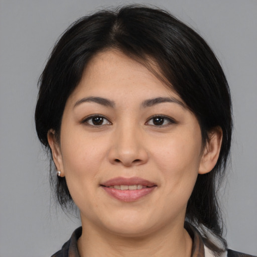Joyful asian young-adult female with medium  black hair and brown eyes