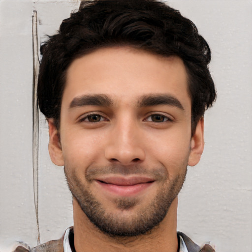 Joyful white young-adult male with short  black hair and brown eyes