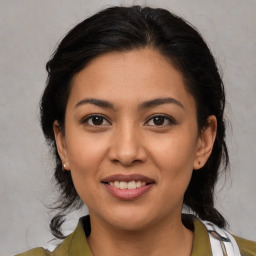 Joyful latino young-adult female with medium  brown hair and brown eyes