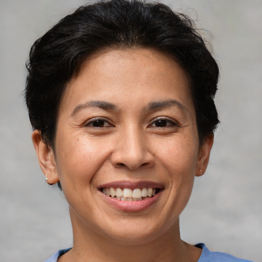 Joyful white adult female with short  brown hair and brown eyes