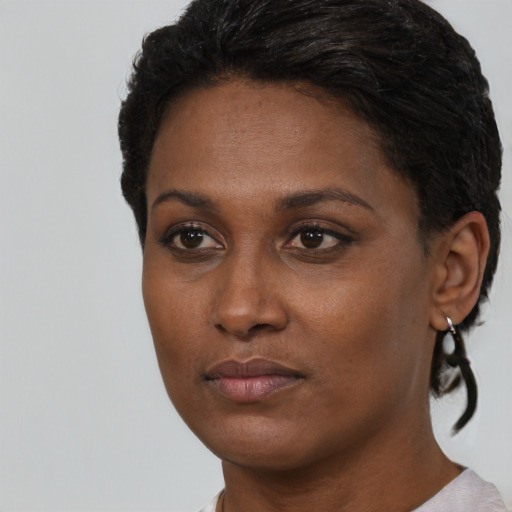 Neutral black young-adult female with short  black hair and brown eyes