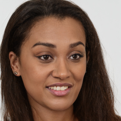 Joyful latino young-adult female with long  brown hair and brown eyes