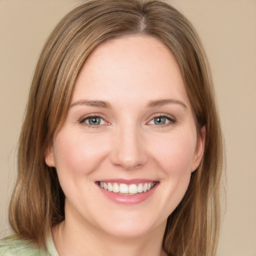 Joyful white young-adult female with medium  brown hair and green eyes