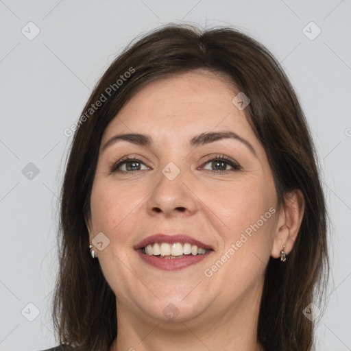 Joyful white adult female with medium  brown hair and grey eyes