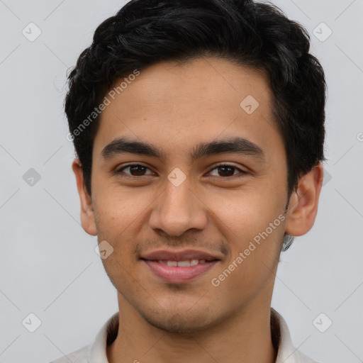 Joyful latino young-adult male with short  brown hair and brown eyes