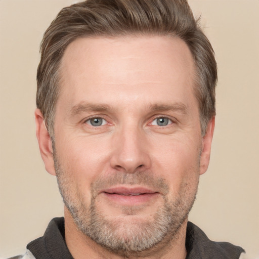 Joyful white adult male with short  brown hair and grey eyes