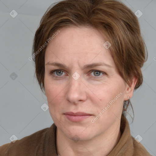 Joyful white adult female with medium  brown hair and blue eyes