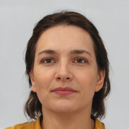 Joyful white adult female with medium  brown hair and brown eyes