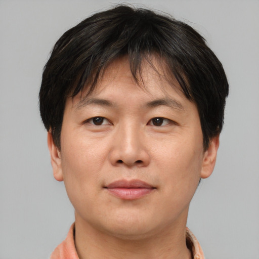Joyful asian adult female with short  brown hair and brown eyes