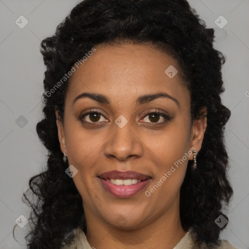 Joyful black young-adult female with long  black hair and brown eyes