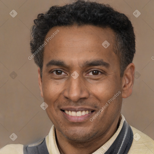 Joyful latino adult male with short  brown hair and brown eyes