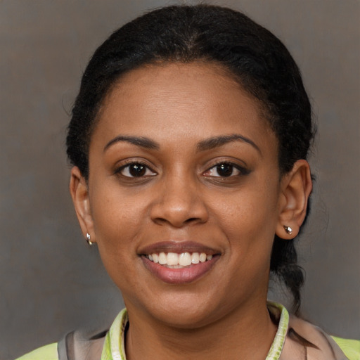 Joyful black young-adult female with short  brown hair and brown eyes