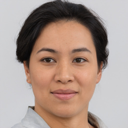 Joyful asian young-adult female with short  brown hair and brown eyes