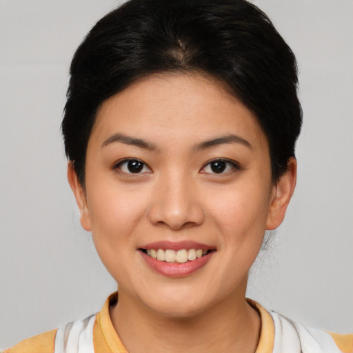 Joyful asian young-adult female with short  brown hair and brown eyes