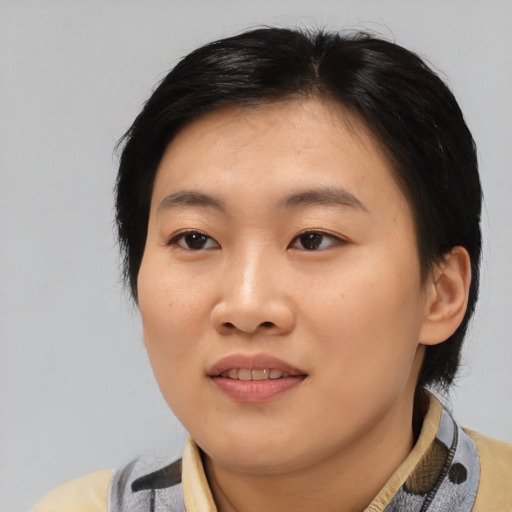 Joyful asian young-adult female with medium  black hair and brown eyes