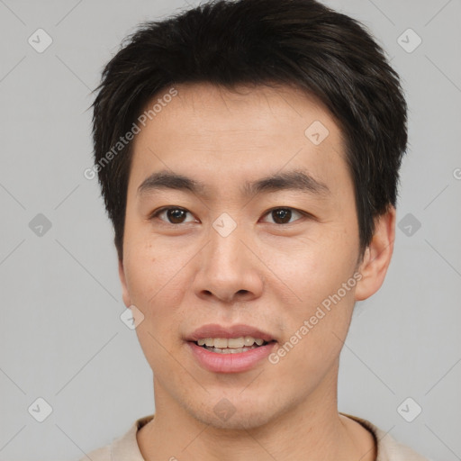 Joyful asian young-adult male with short  brown hair and brown eyes