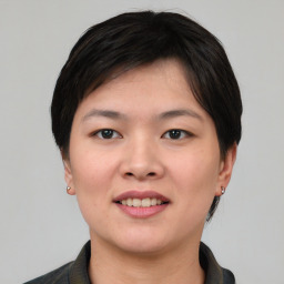 Joyful asian young-adult female with short  black hair and brown eyes