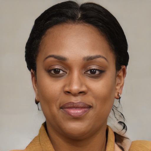 Joyful black adult female with short  brown hair and brown eyes