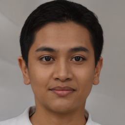 Joyful latino young-adult male with short  brown hair and brown eyes