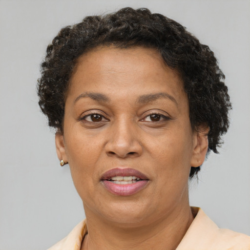 Joyful black adult female with short  brown hair and brown eyes