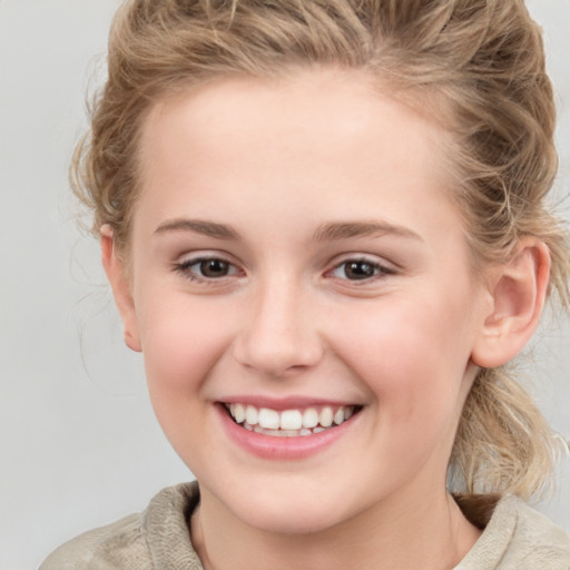 Joyful white child female with medium  brown hair and brown eyes