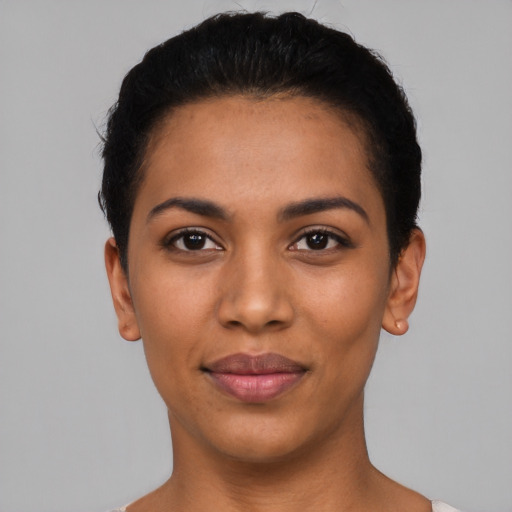 Joyful latino young-adult female with short  black hair and brown eyes
