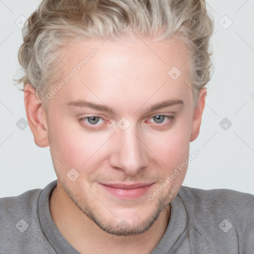 Joyful white young-adult male with short  brown hair and blue eyes