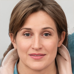 Joyful white adult female with medium  brown hair and grey eyes