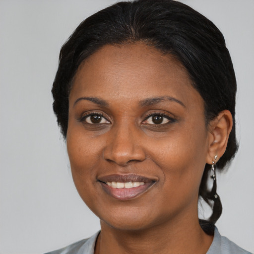 Joyful black young-adult female with medium  black hair and brown eyes