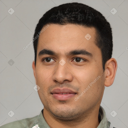 Joyful latino young-adult male with short  black hair and brown eyes