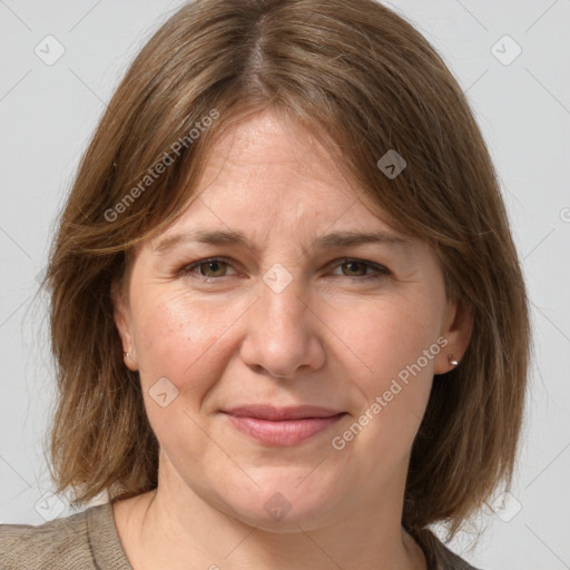 Joyful white adult female with medium  brown hair and grey eyes