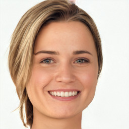 Joyful white young-adult female with long  brown hair and green eyes