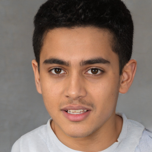 Joyful latino young-adult male with short  brown hair and brown eyes